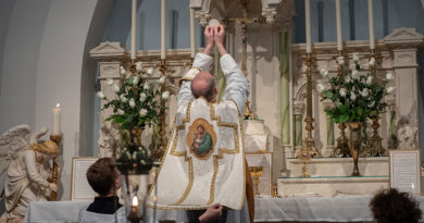 Priest consecrating the host in latin mass