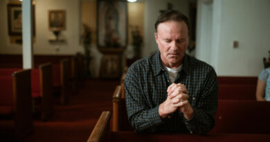 A man praying at a church